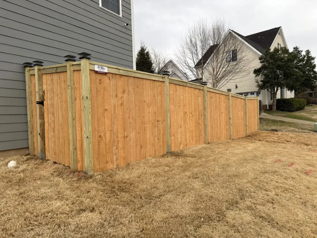 Wood privacy fence with a latched side-yard gate